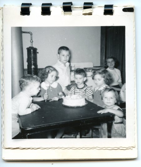 Birthday Party, 1953. I'm the little one in the full length plastic bib, watching the camera, not the cake.